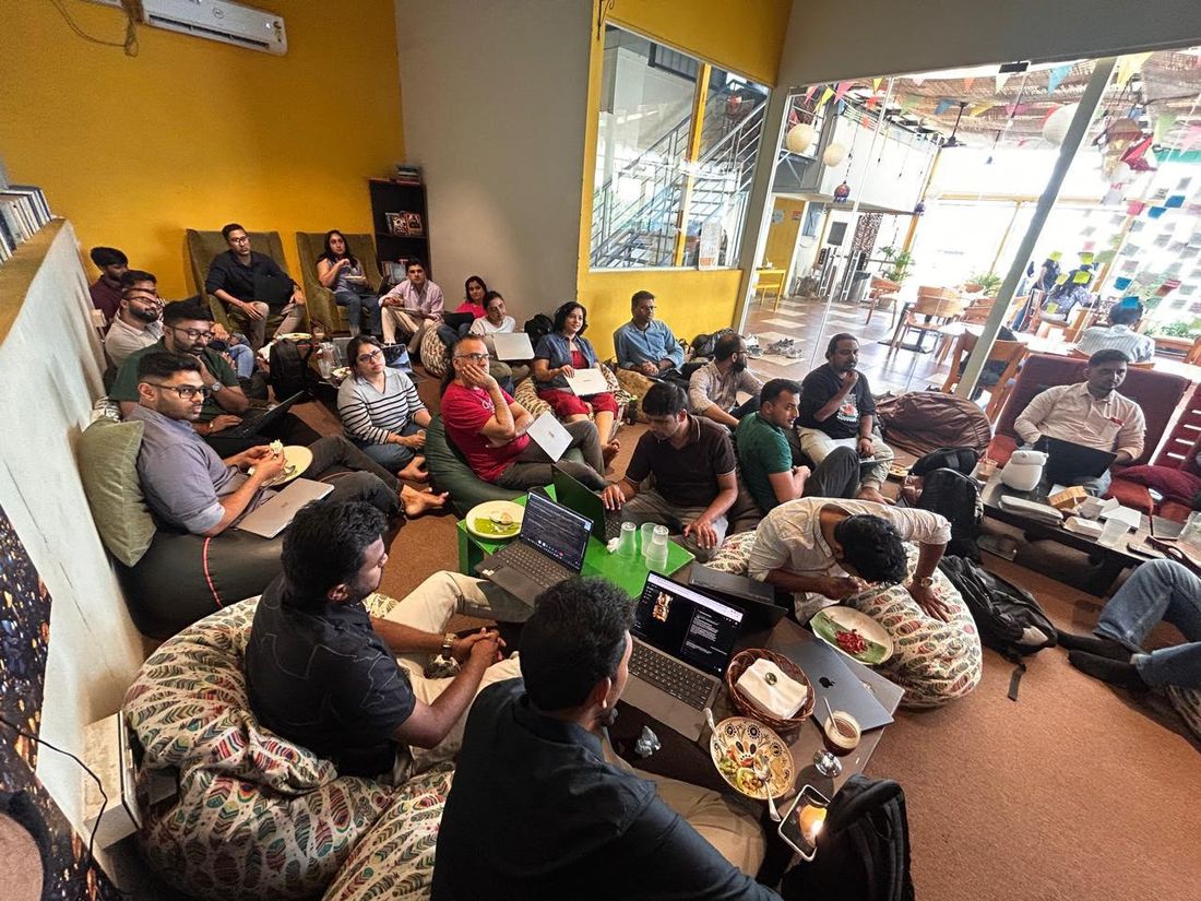 The room — people on beanbags with laptops open, coffee and conversation